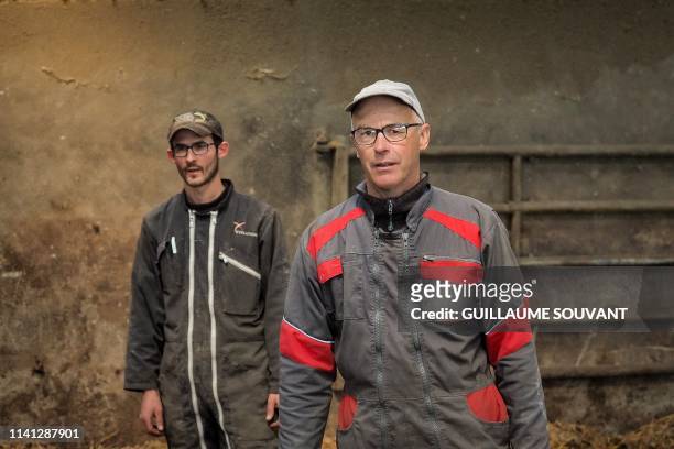 Farmers, breeder of Charolais cows, Jean-Luc Jaulin and his son Alban are pictured in their farm on April 26, 2019 in La Jauniere near Chiche,...