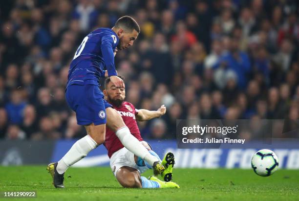 Eden Hazard of Chelsea beats Ryan Fredericks of West Ham United as he scores his team's first goal during the Premier League match between Chelsea FC...