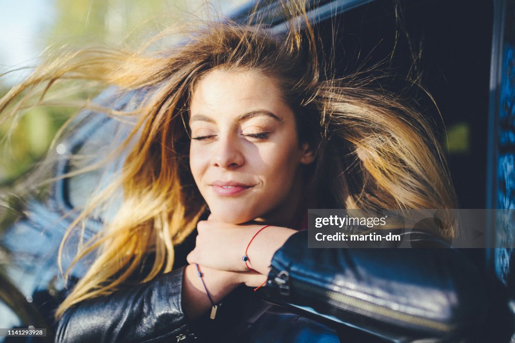 Woman on a road trip with car