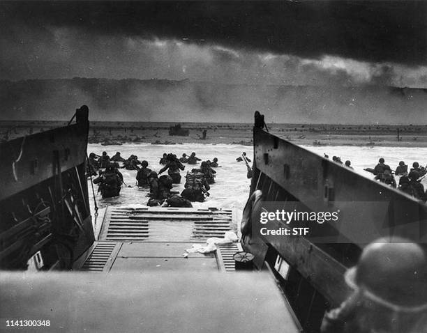 This photograph from the National Archives taken on June 6 shows US Army troops wading ashore at Omaha Beach in north-western France, during the...