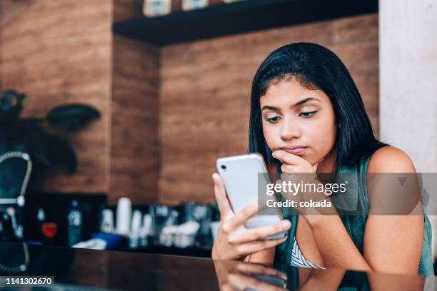 young teenager using smartphone at the kitchen - ghosted stock pictures, royalty-free photos & images