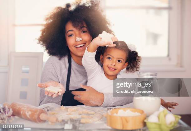 mother and daughter are baking together - massage funny stock pictures, royalty-free photos & images