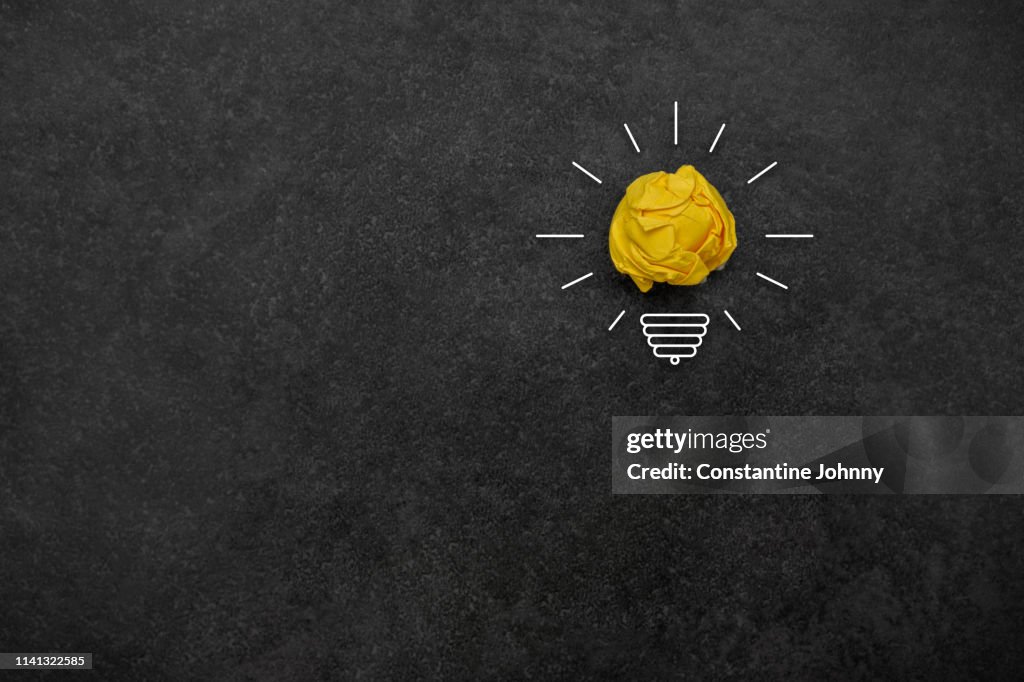 Bulb Concepts with Yellow Crumpled Paper Ball