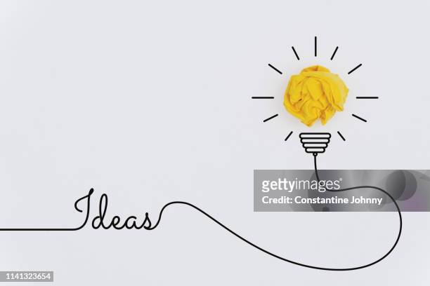 bulb idea concepts with yellow crumpled paper ball - business drawing white background stock pictures, royalty-free photos & images