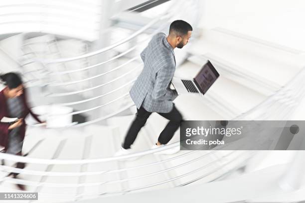 businessman walking up stairs - office motion stock pictures, royalty-free photos & images