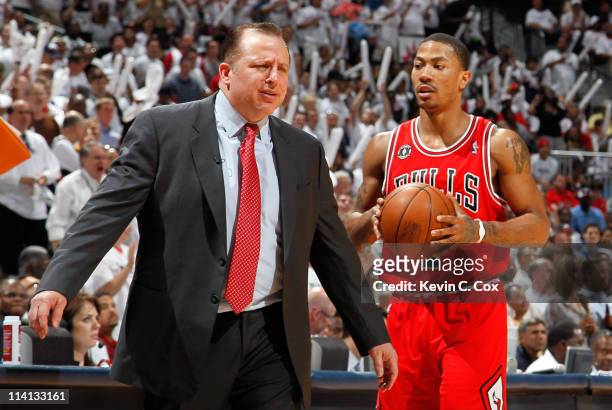 Derrick Rose walks off the court as Tom Thibodeau of the Chicago Bulls reacts after calling a timeout against the Atlanta Hawks in Game Six of the...