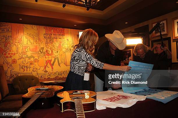 Alan Jackson signs posters backstage at the CMT Disaster Relief Concert on May 12, 2011 in Nashville, Tennessee.