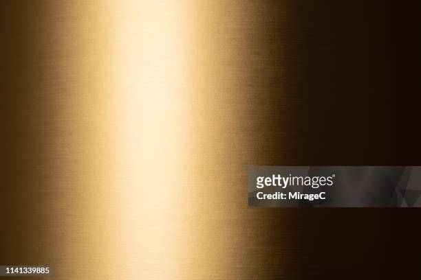golden colored shiny texture - shiny foil stock pictures, royalty-free photos & images