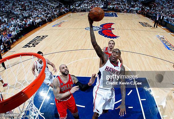 Jamal Crawford of the Atlanta Hawks drives the basket against Carlos Boozer of the Chicago Bulls in Game Six of the Eastern Conference Semifinals in...