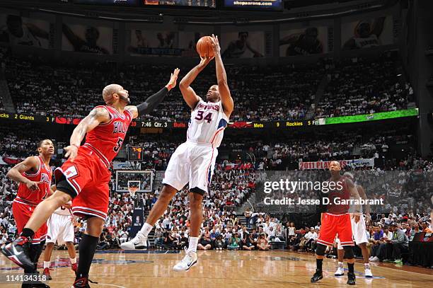 Jason Collins of the Atlanta Hawks shoots against Carlos Boozer of the Chicago Bulls during Game Six of the Eastern Conference Semifinals in the 2011...