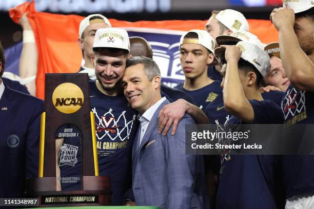 Ty Jerome and head coach Tony Bennett of the Virginia Cavaliers celebrate their teams 85-77 win over the Texas Tech Red Raiders to win the the 2019...