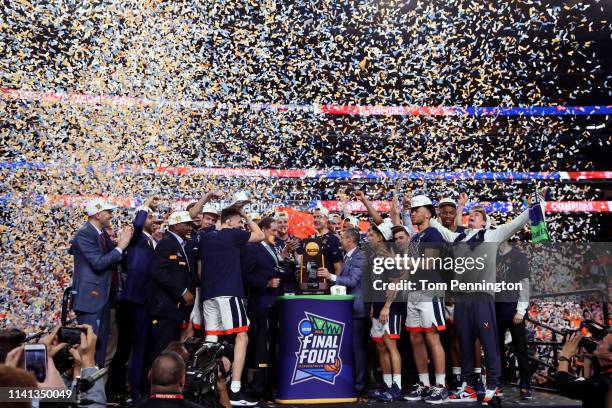 The Virginia Cavaliers celebrate with the trophy after their 85-77 win over the Texas Tech Red Raiders during the 2019 NCAA men's Final Four National...