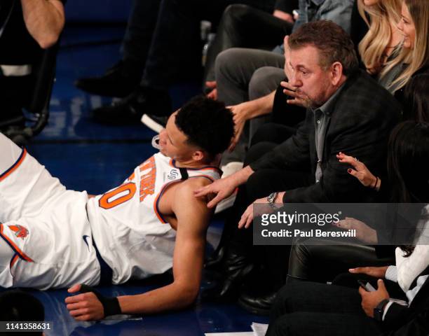 New York Knicks owner James Dolan reacts to Kevin Knox of the Knicks falling at his feet as he watches an NBA basketball game against the Toronto...