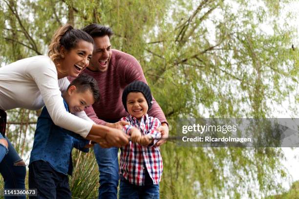 family plays around the lake - latin script stock pictures, royalty-free photos & images