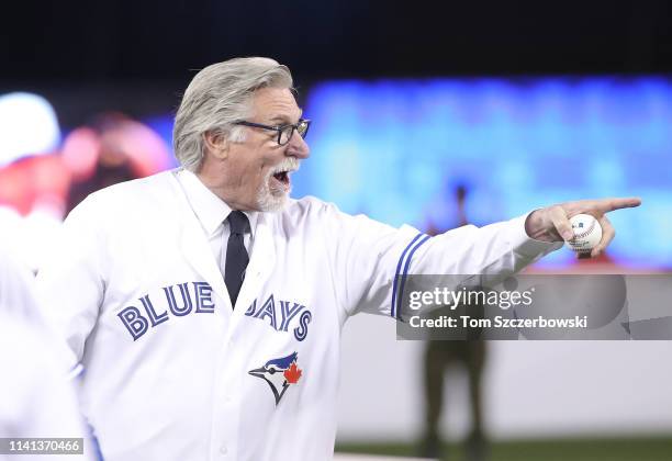 Former pitcher and Hall of Fame member Jack Morris points to the Detroit Tigers team after throwing out the ceremonial first pitch on Opening Day...