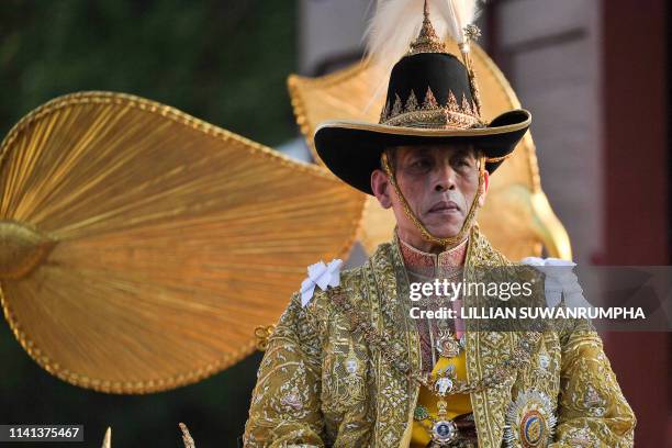 Thailand's King Maha Vajiralongkorn is carried in a golden palanquin out of the Grand Palace for the coronation procession in Bangkok on May 5, 2019.