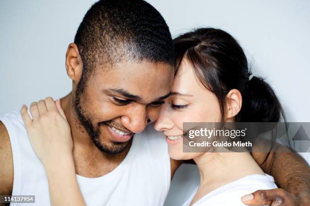 young couple smiling cheek to cheek - guancia a guancia foto e immagini stock