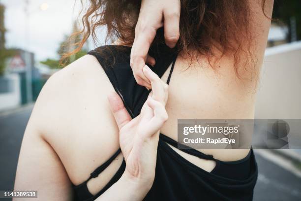 young woman clasps hands behind back, stretching before exercising - scapula stock pictures, royalty-free photos & images