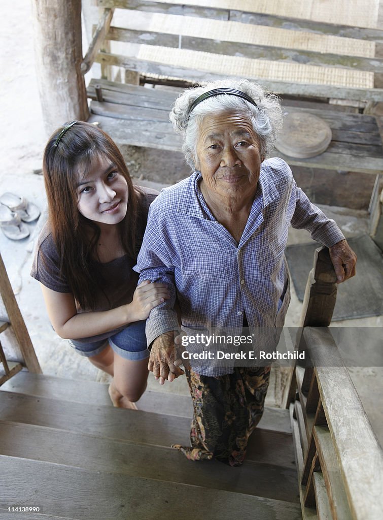 Granddaughter helping grandmother upstairs