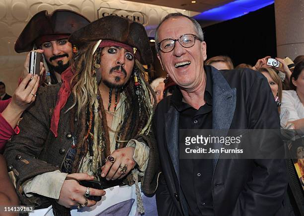 Actor Geoffrey Rush poses with a fan as he arrives for the UK Premiere of 'Pirates Of The Caribbean: On Stranger Tides' at Vue Westfield on May 12,...