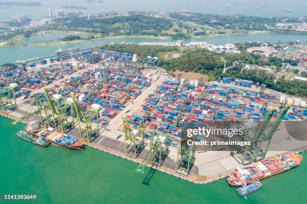 logistics and transportation of container cargo ship and cargo with working crane bridge in shipyard at sunrise, logistic import export and transport industry background - indonesia aerial stock pictures, royalty-free photos & images