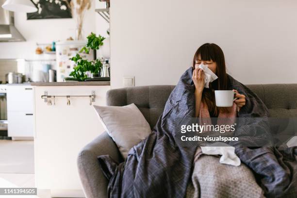 asian woman sick at home with common cold - cold illness stock pictures, royalty-free photos & images