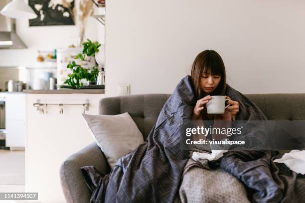 asian woman sick at home - asian drinking tea stock pictures, royalty-free photos & images