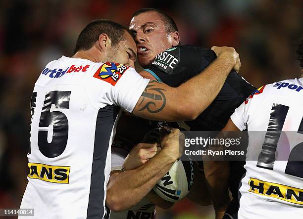 Dayne Weston of the Panthers is tackled by Scott Anderson of the Broncos during the round 10 NRL match between the Penrith Panthers and the Brisbane...