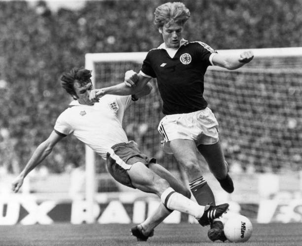 England 1-2 Scotland, British Home Championship, Wembley Stadium, Saturday 4th June 1977; pictured: Gordon McQueen of Scotland is tackled by Dave...