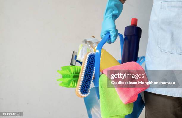 man holding mop and plastic bucket with brushes, gloves and detergents in the kitchen - clearing products fotografías e imágenes de stock