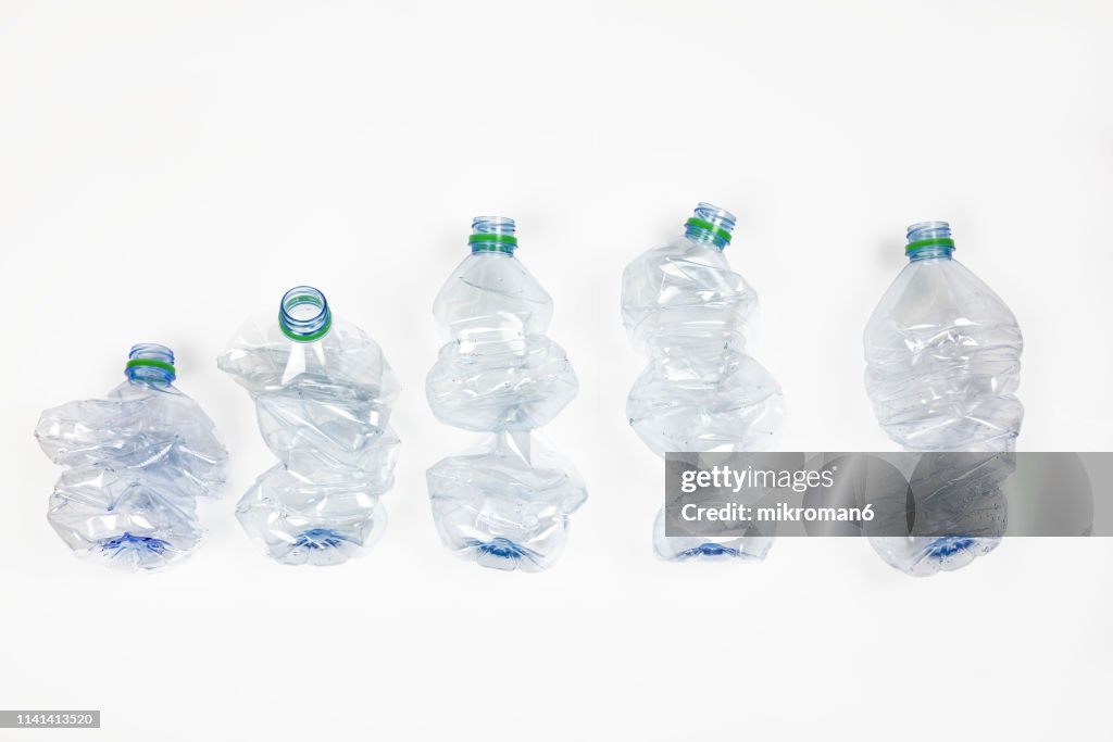 Group of crumpled plastic drink water bottles for recycling