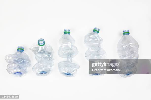 group of crumpled plastic drink water bottles for recycling - plastic bottle stock pictures, royalty-free photos & images