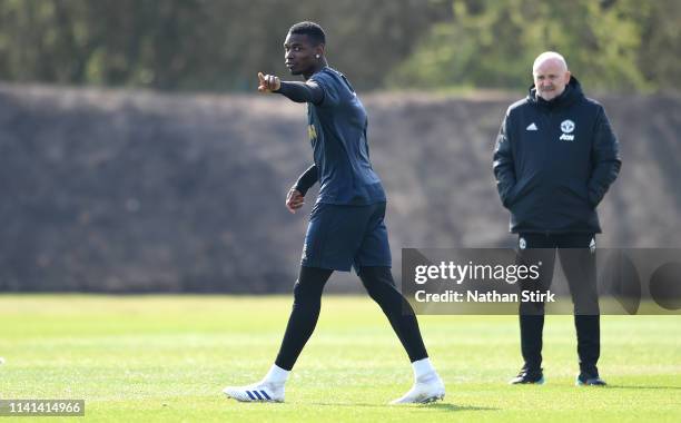 Paul Pogba of Manchester United gestures as Mike Phelan, Manchester United first team coach looks on during the Manchester United training session...