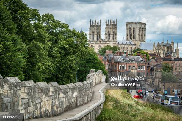 View of the York Minster towering over the historic city of York from the city walls, Yorkshire, United Kingdom.
