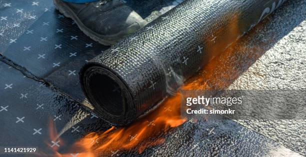 heating and melting of bitumen rolls - flat stock pictures, royalty-free photos & images