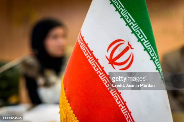 iranian flag on conference table - iranian flag stock-fotos und bilder