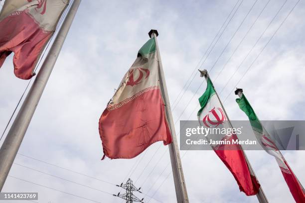 iranian flag on street - iranian flag stock pictures, royalty-free photos & images