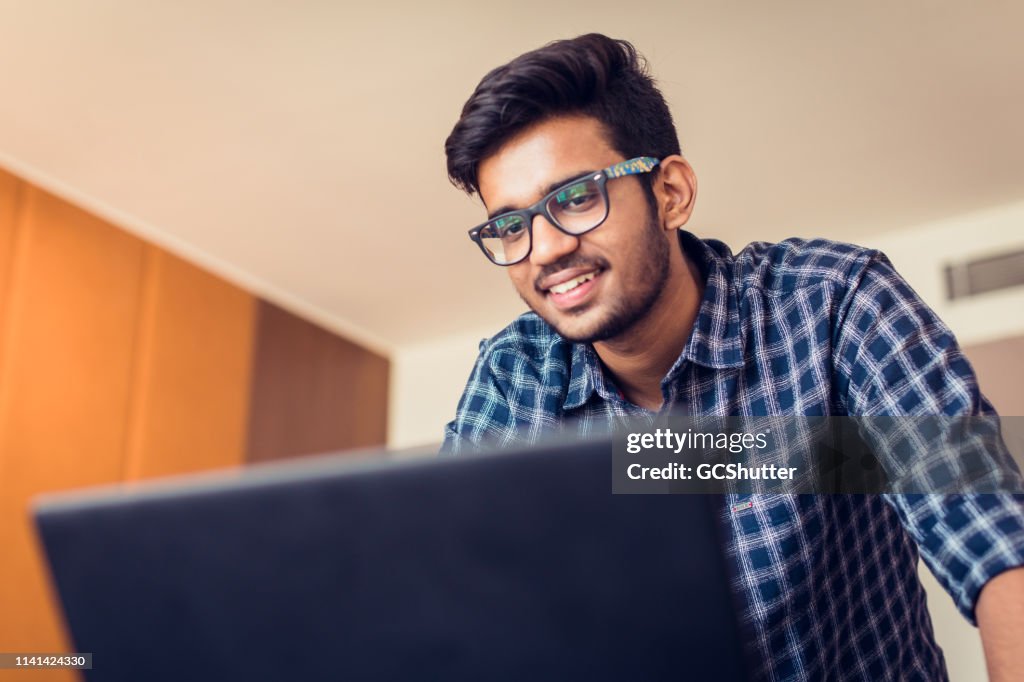 Young Man doing a Video Conferencing using his laptop
