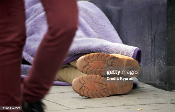 homeless man sleeping on pavement, oxford street - homelessness stock pictures, royalty-free photos & images