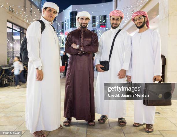 arab boys in city at night - qatar man stock pictures, royalty-free photos & images