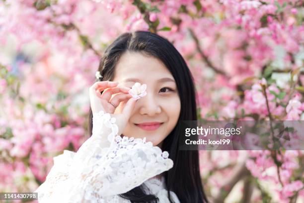 young girl and spring flowers - beautiful college girls stock pictures, royalty-free photos & images