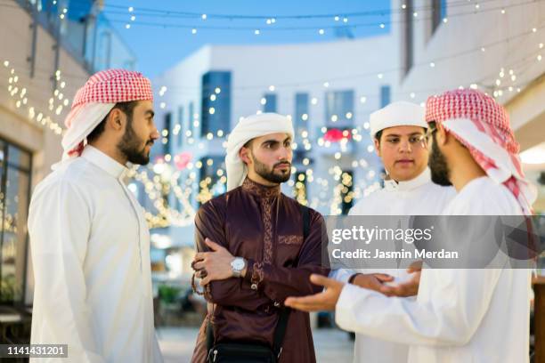 arab guys talking - middle east market stock pictures, royalty-free photos & images