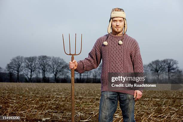 young farmer with pitchfork - heugabel stock-fotos und bilder