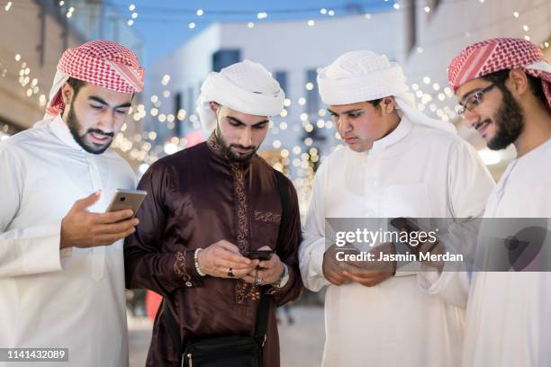 arabic boys with smartphones - middle east friends stock pictures, royalty-free photos & images