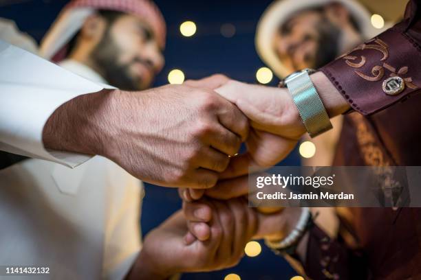 two arabs holding hands - arabische familie stock-fotos und bilder