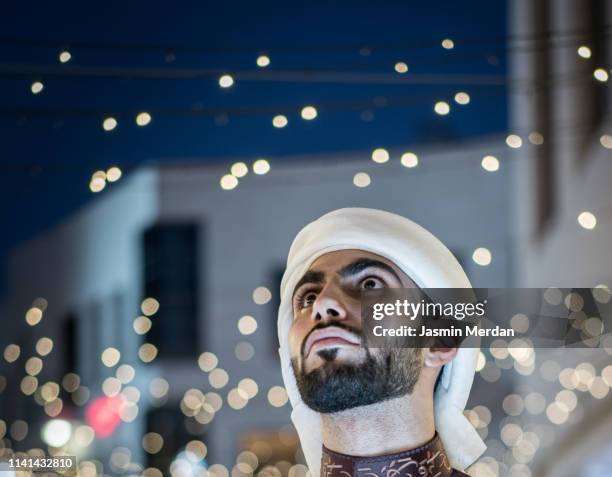 arab young man on night street - young muslim man stockfoto's en -beelden