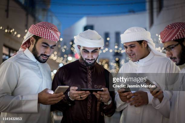 arabic boys with smartphones - arabic people ストックフォトと画像