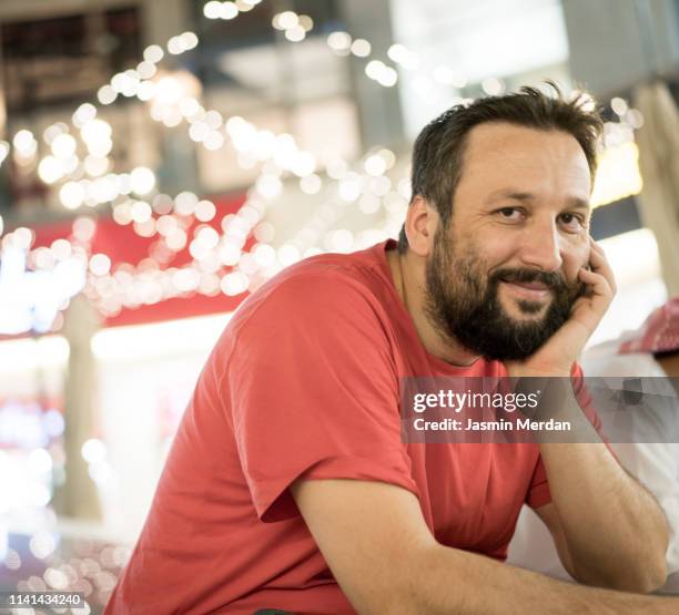 man sitting alone on street and smiling - amman people stock pictures, royalty-free photos & images