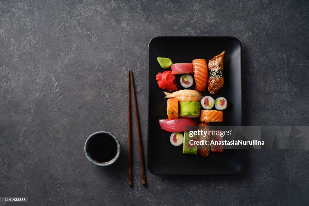 Overhead image of variety of sushi and rolls served on a plate. Shrimp, unagi, crab, salmon and tuna