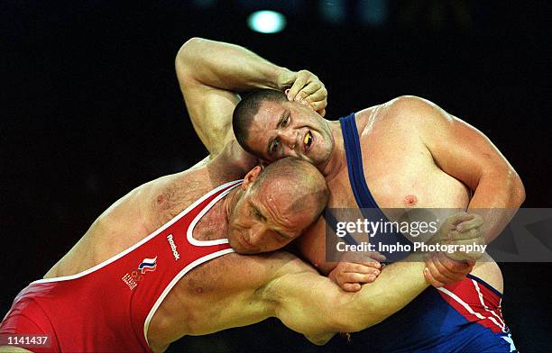 Rulon Gardner of USA, right, wrestles against Alexandre Karelin of Russia in the 130 kilogram event September 27, 2000 during the Sydney 2000 Olympic...